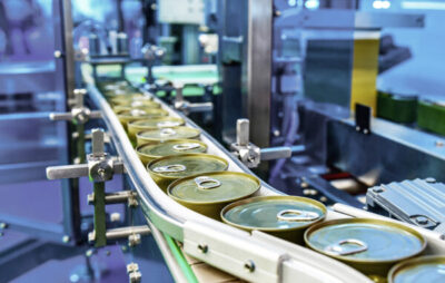 Canned food products on conveyor belt in distribution warehouse. automatic packaging industry