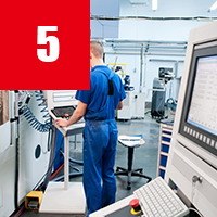 worker operating CNC machine center