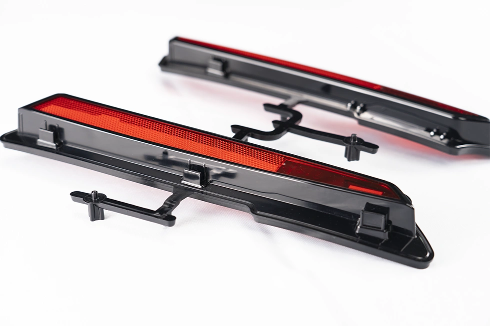 two-shot molded automotive headlight parts